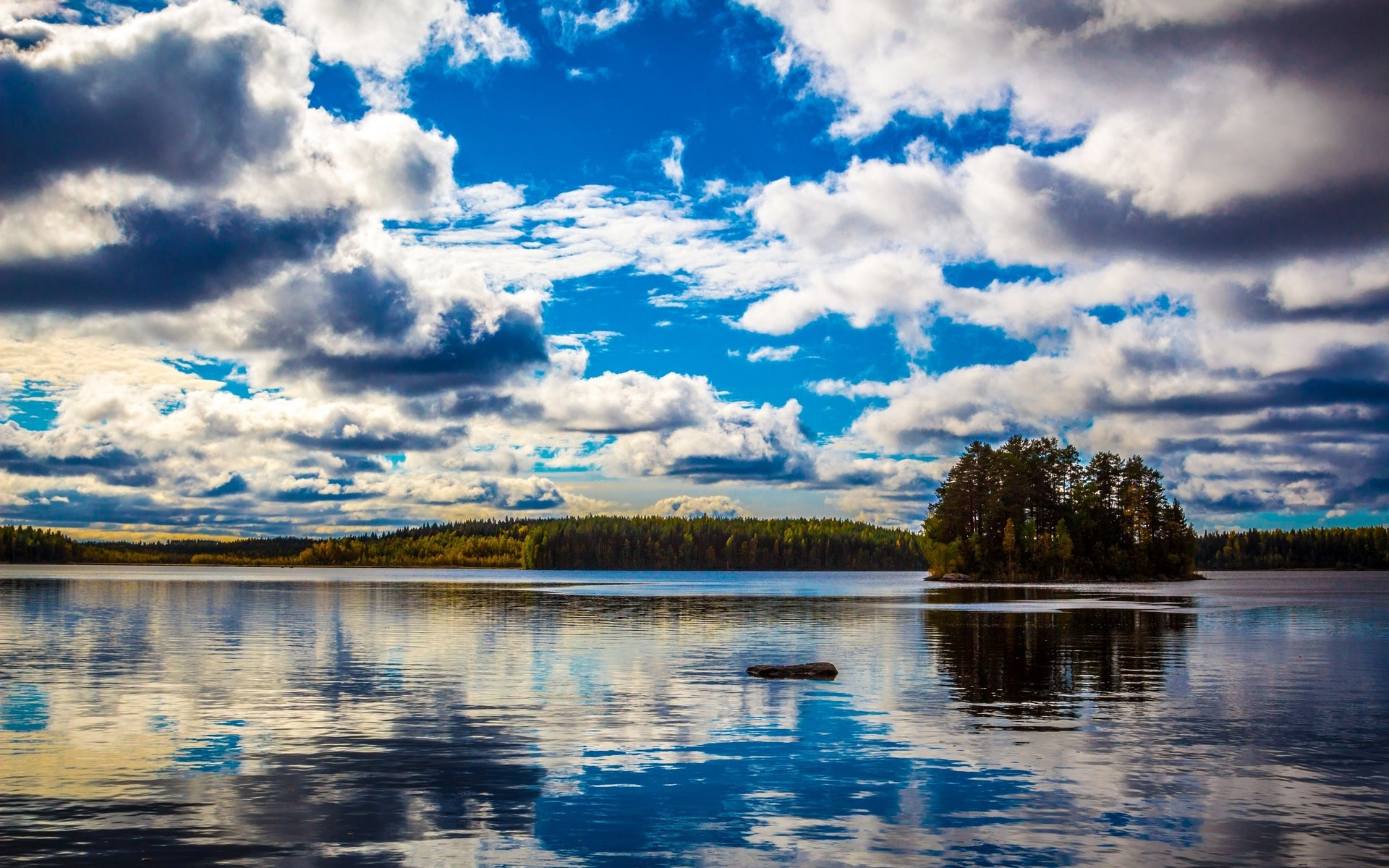 Island in a lake under a cloudy sky HD Wallpaper