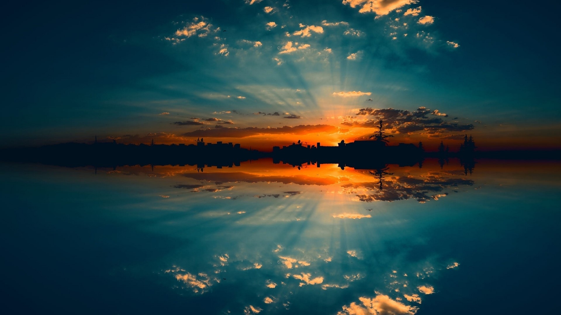 Sunset over city skyline reflected in water HD Wallpaper