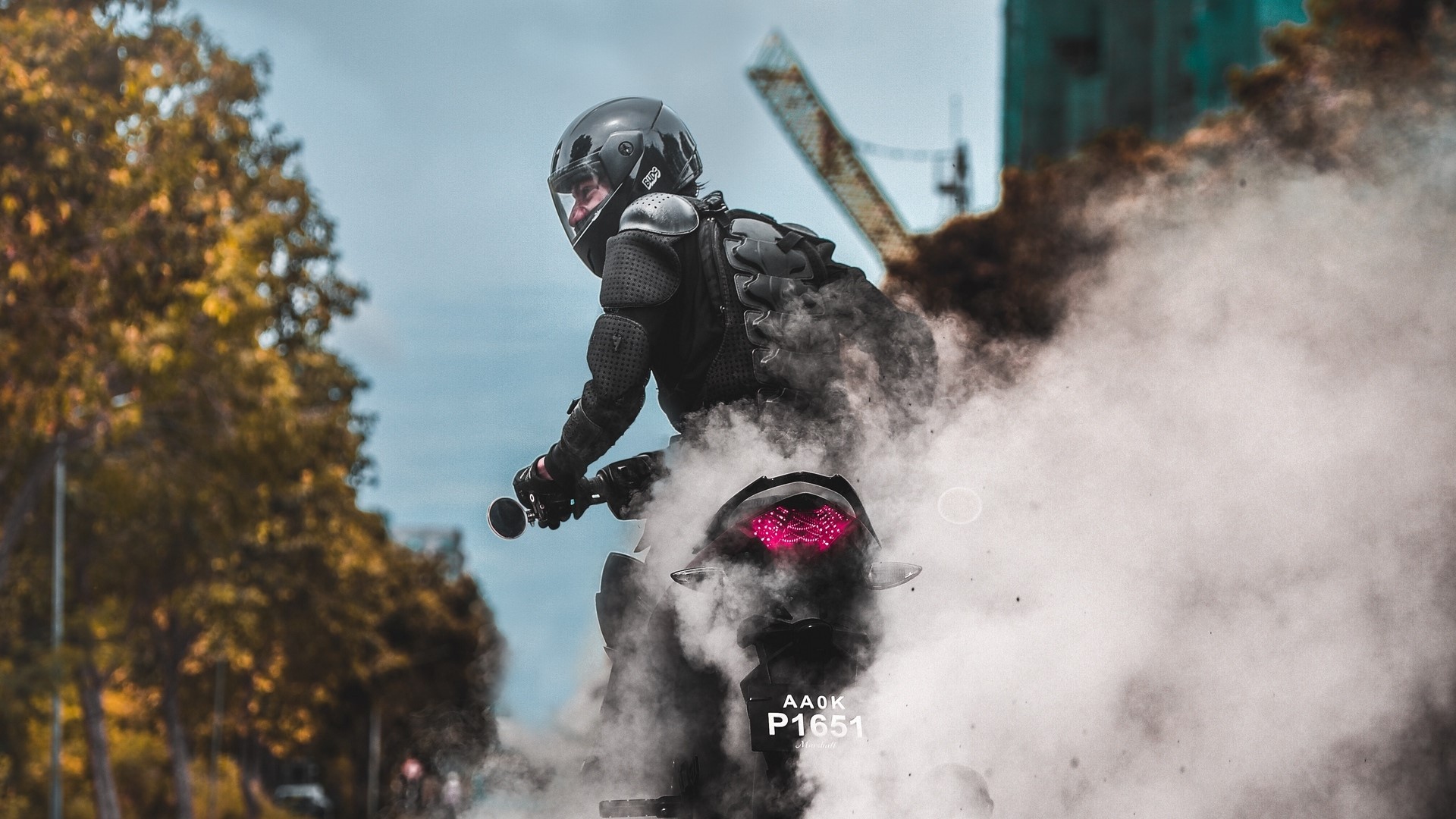 Biker performing a burnout with smoke HD Wallpaper
