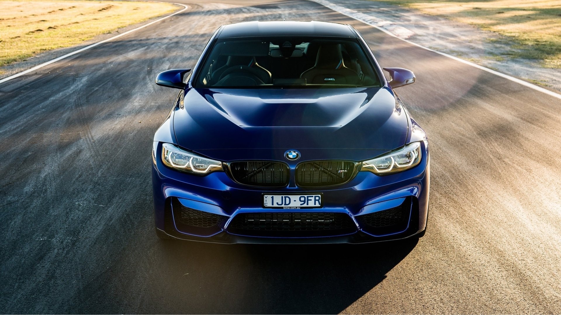 Blue BMW M4 on a Racetrack HD Wallpaper