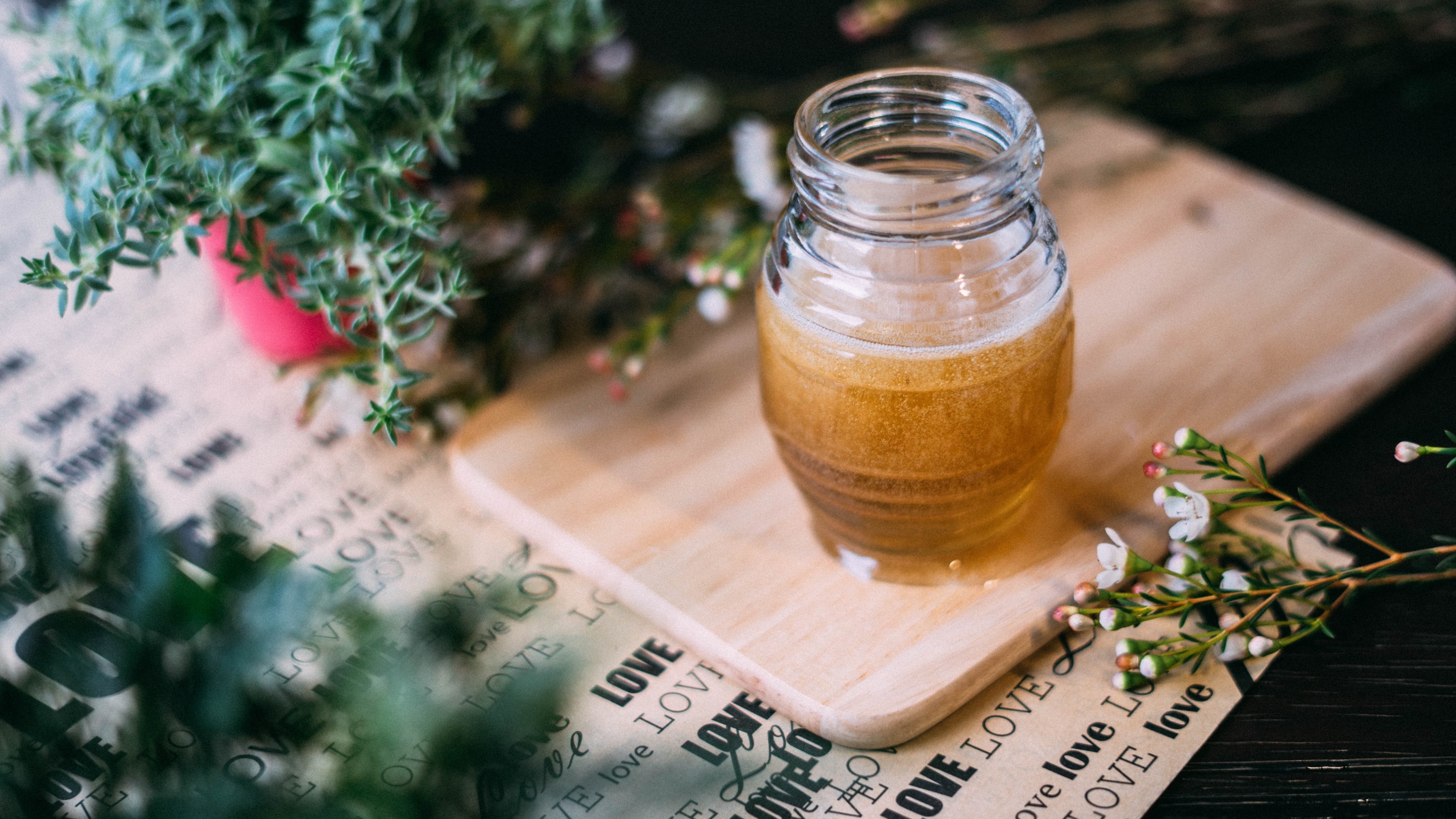Jar of honey with herbs and flowers HD Wallpaper