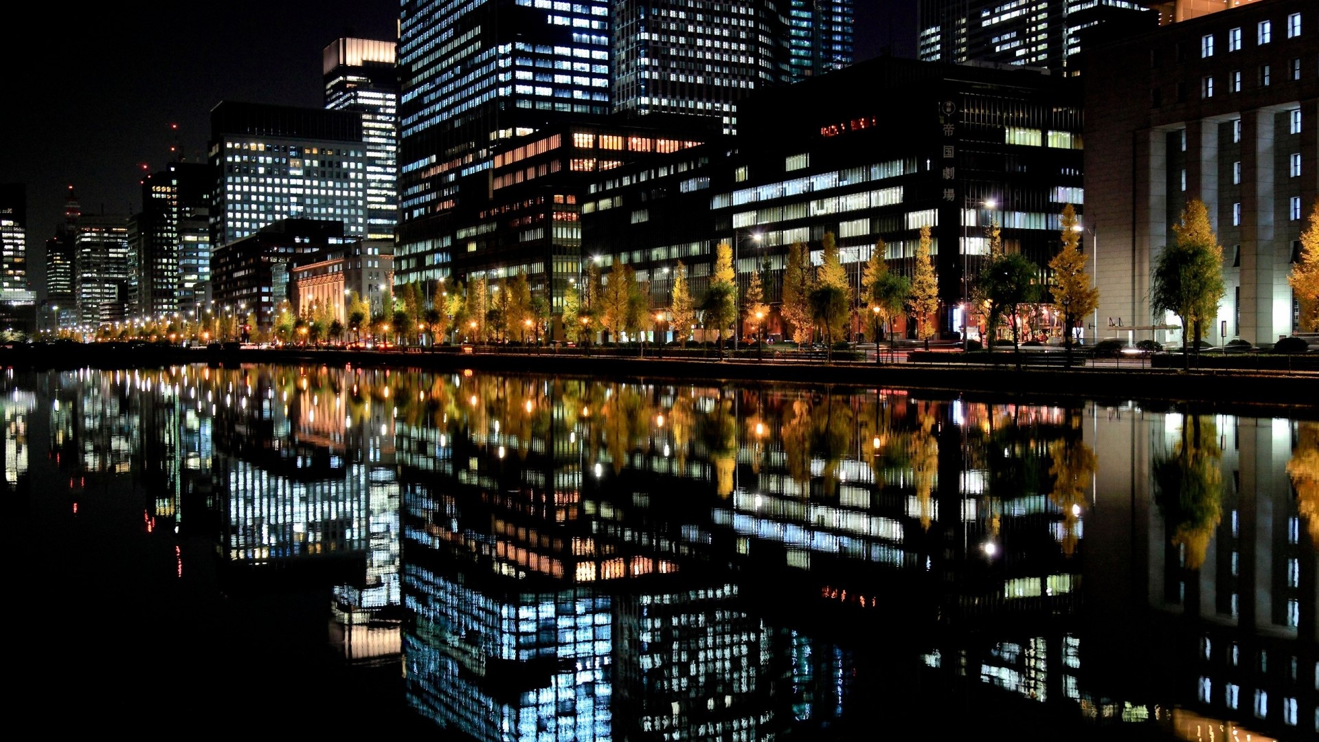 Tokyo cityscape at night with reflections in water HD Wallpaper