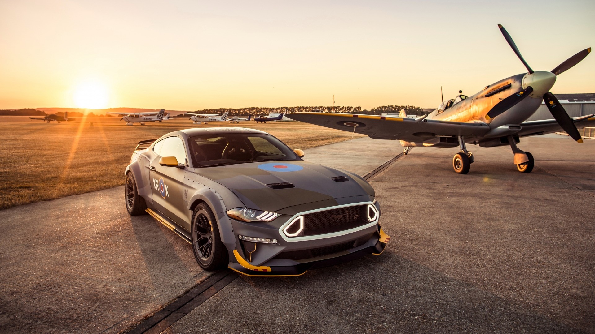 Ford Mustang GT and Spitfire airplane at sunset HD Wallpaper