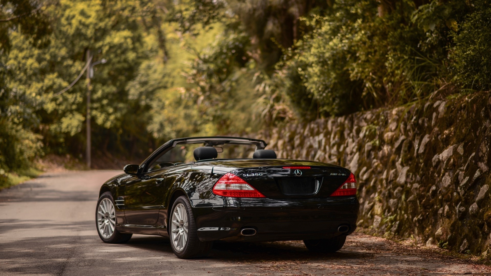 Black Mercedes-Benz SL350 AMG Convertible on a Road HD Wallpaper