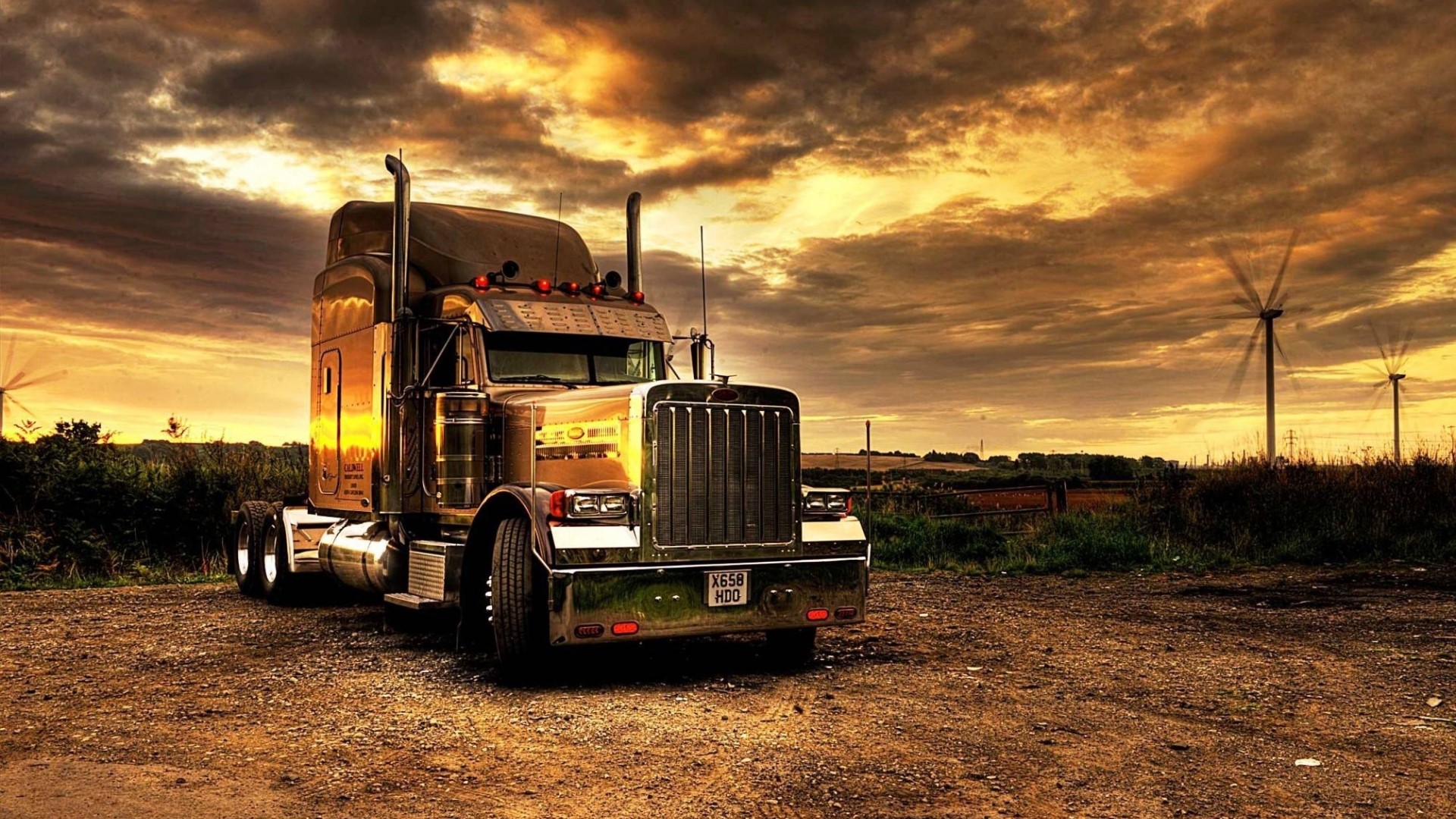 Chrome Semi-Truck at Sunset with Wind Turbines HD Wallpaper