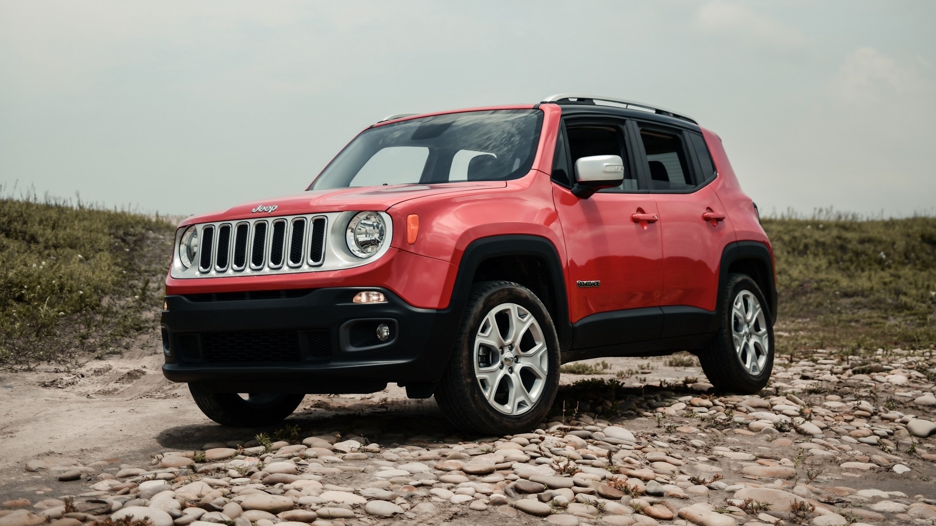 Red Jeep Renegade on a rocky path HD Wallpaper
