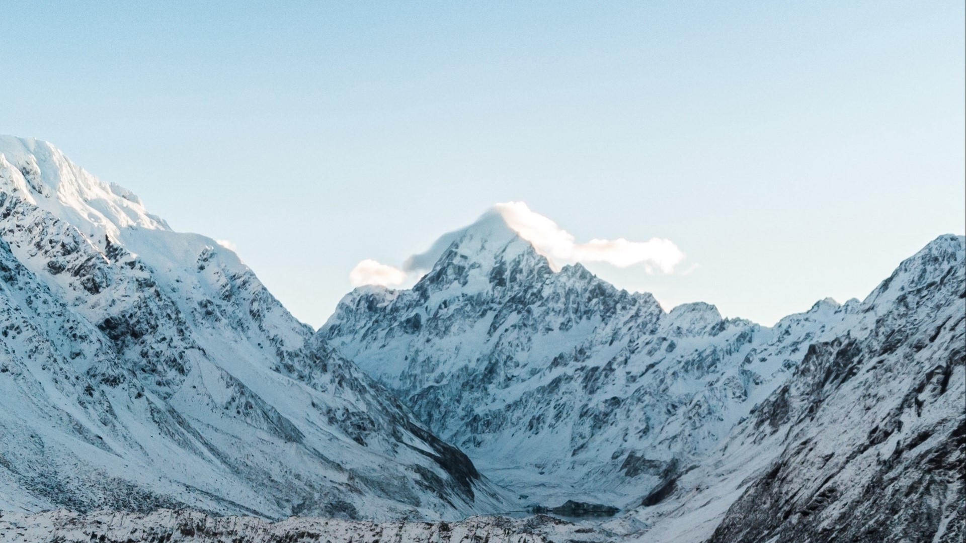 Snow-covered mountains under a clear sky HD Wallpaper