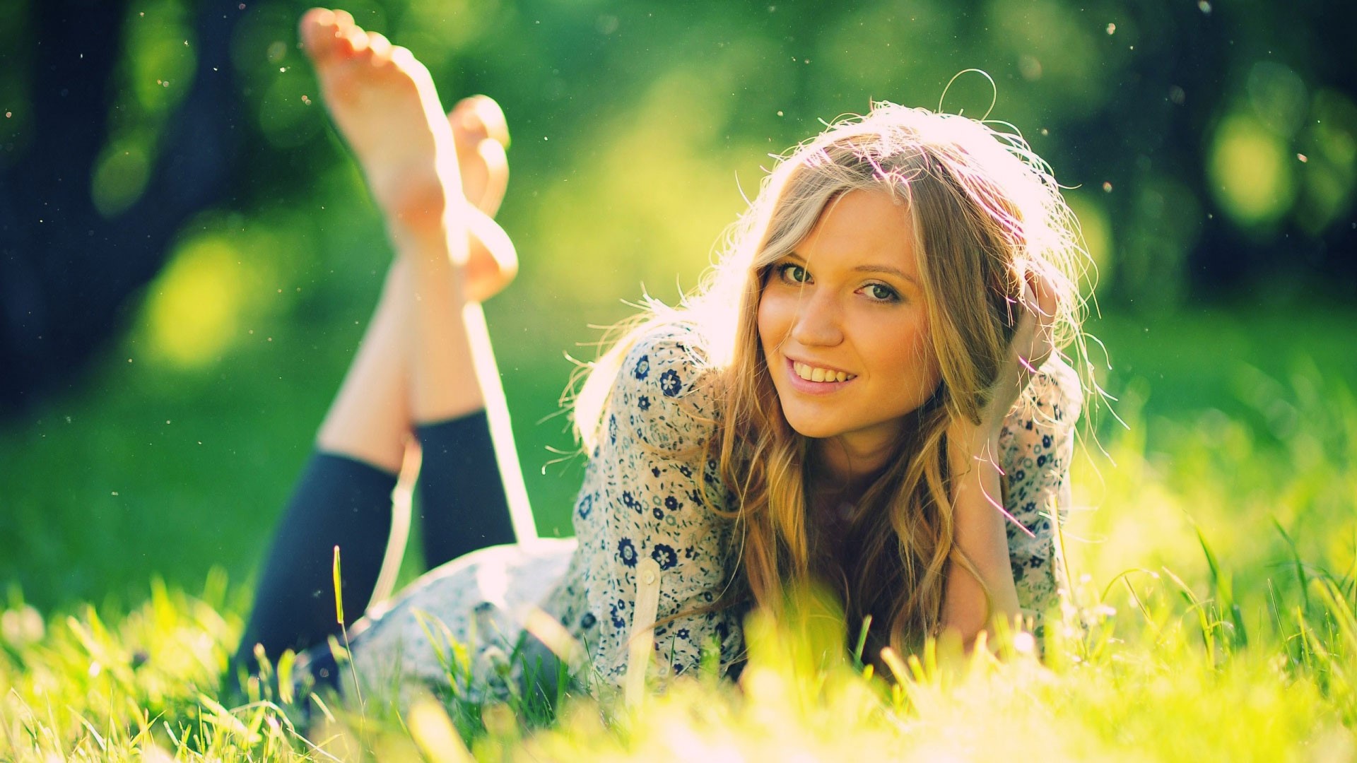 Blonde woman lying on grass HD Wallpaper