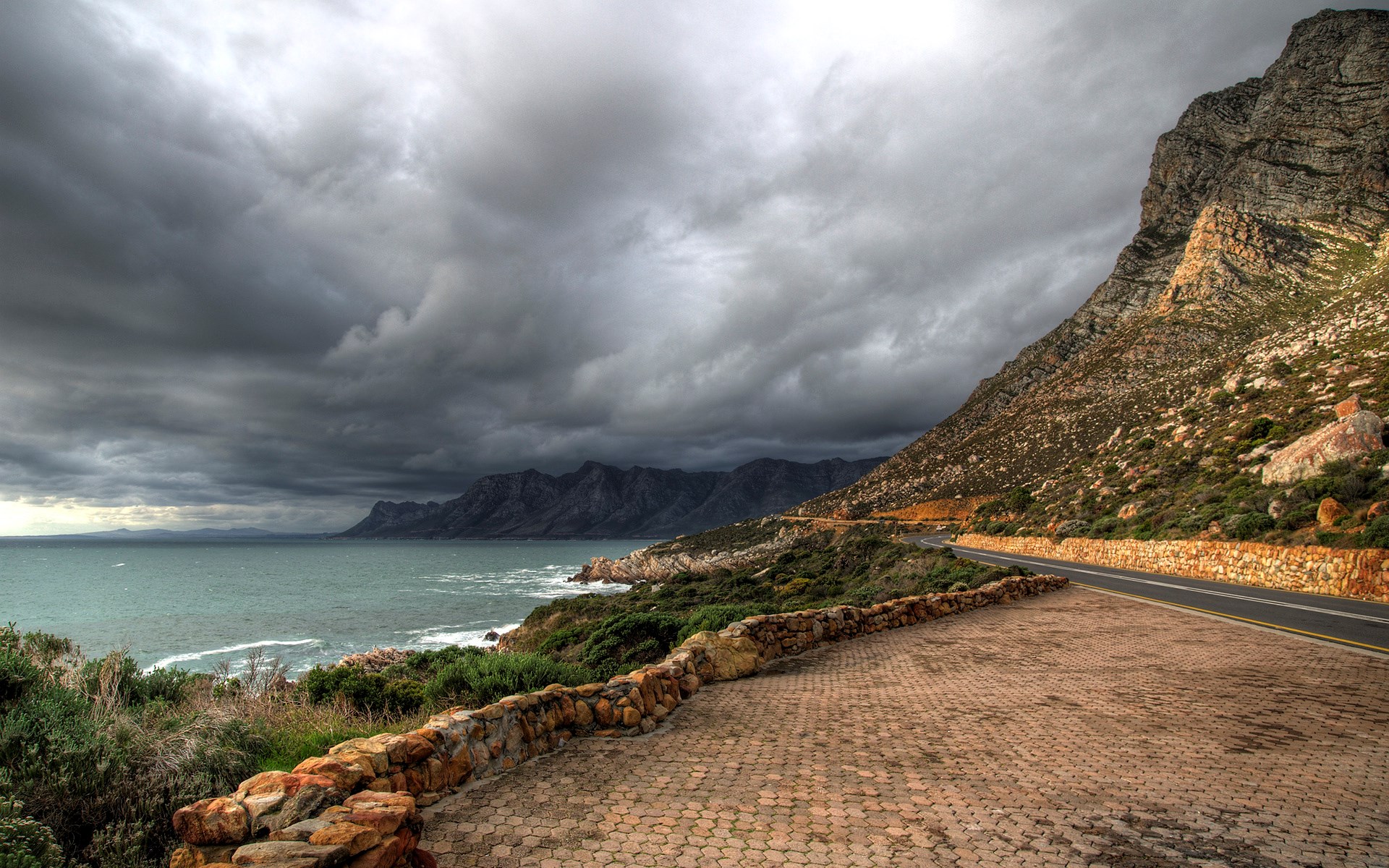 Coastal Road with Mountains and Stormy Sky HD Wallpaper