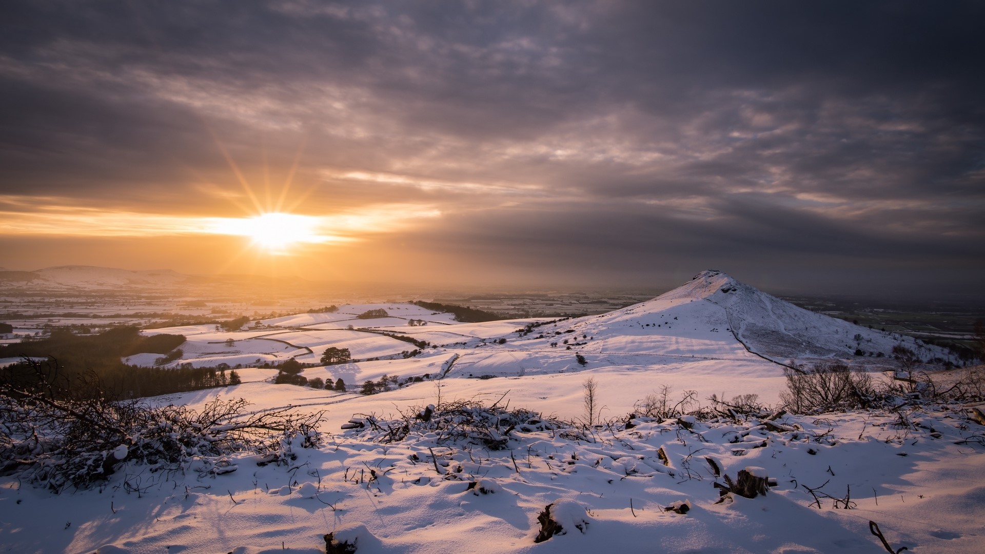 Snowy landscape with sunset over hills HD Wallpaper