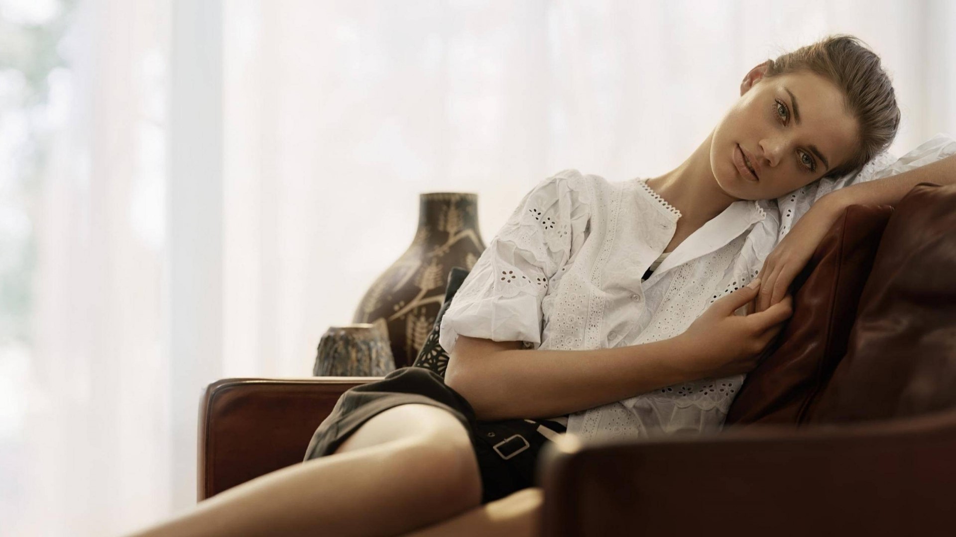 Woman in white shirt resting on couch HD Wallpaper