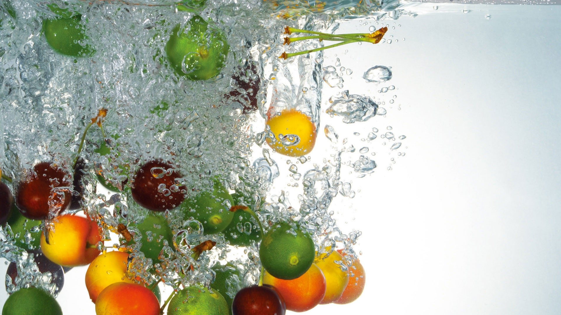 Fruits splashing into water HD Wallpaper