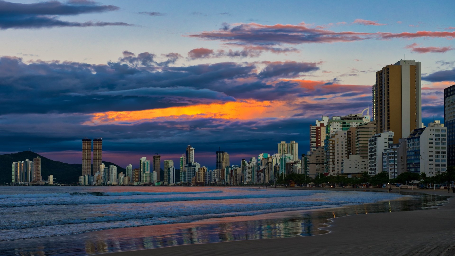 City skyline on a beach at sunset HD Wallpaper