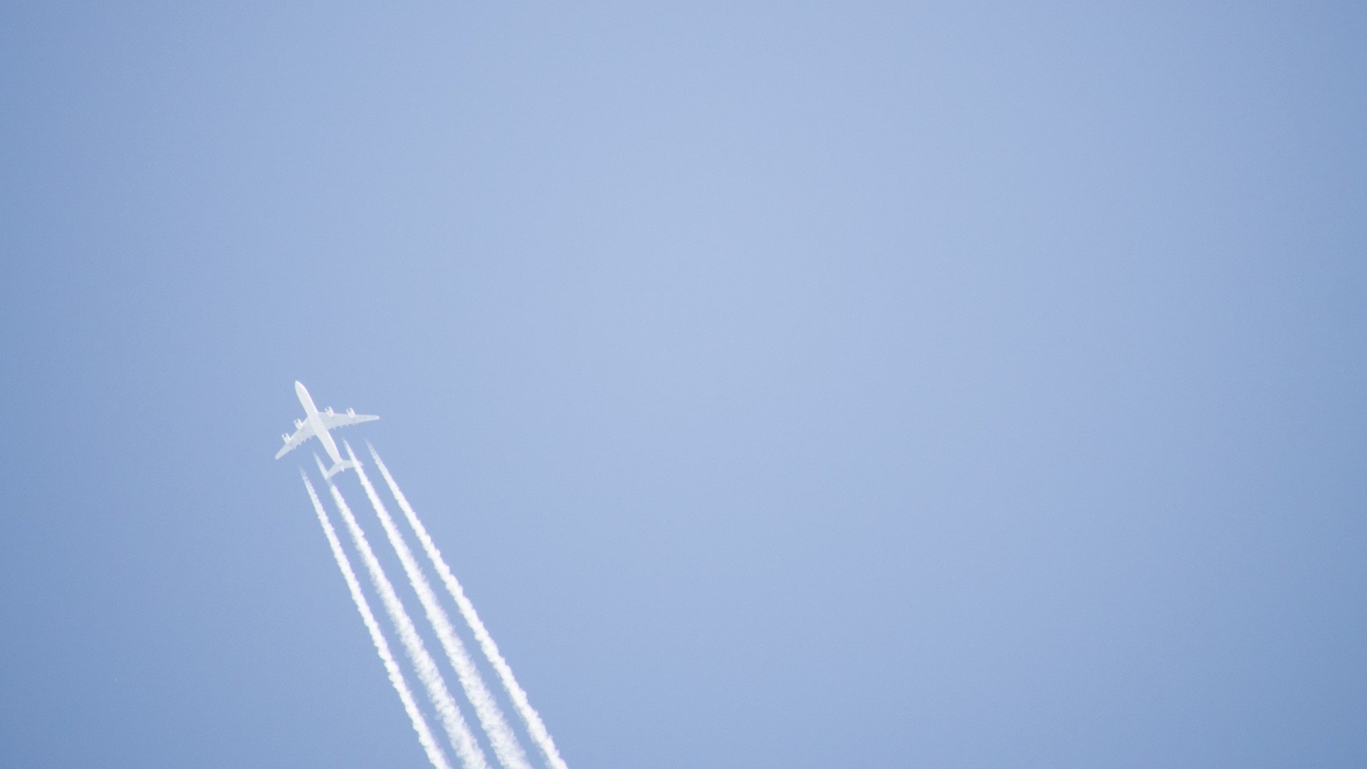 Airplane leaving contrails in a clear sky HD Wallpaper