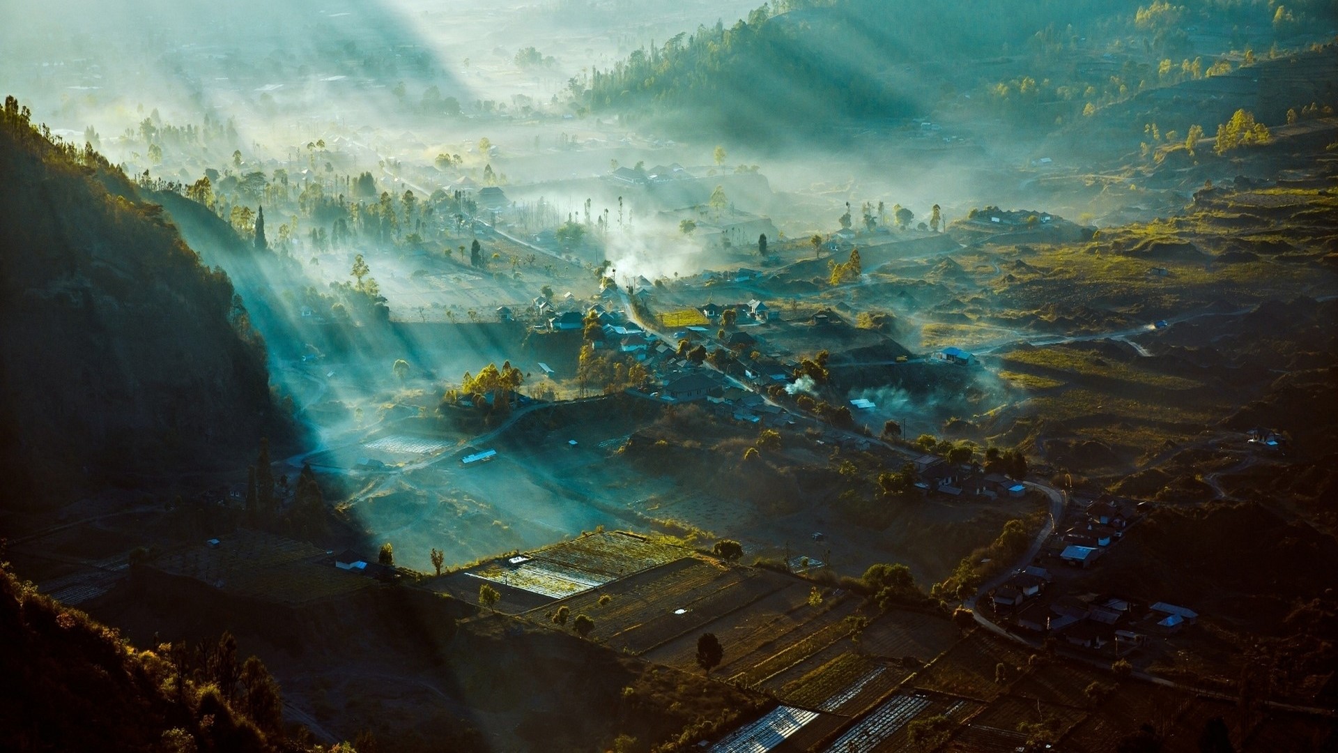 Misty valley with sunbeams in Indonesia HD Wallpaper