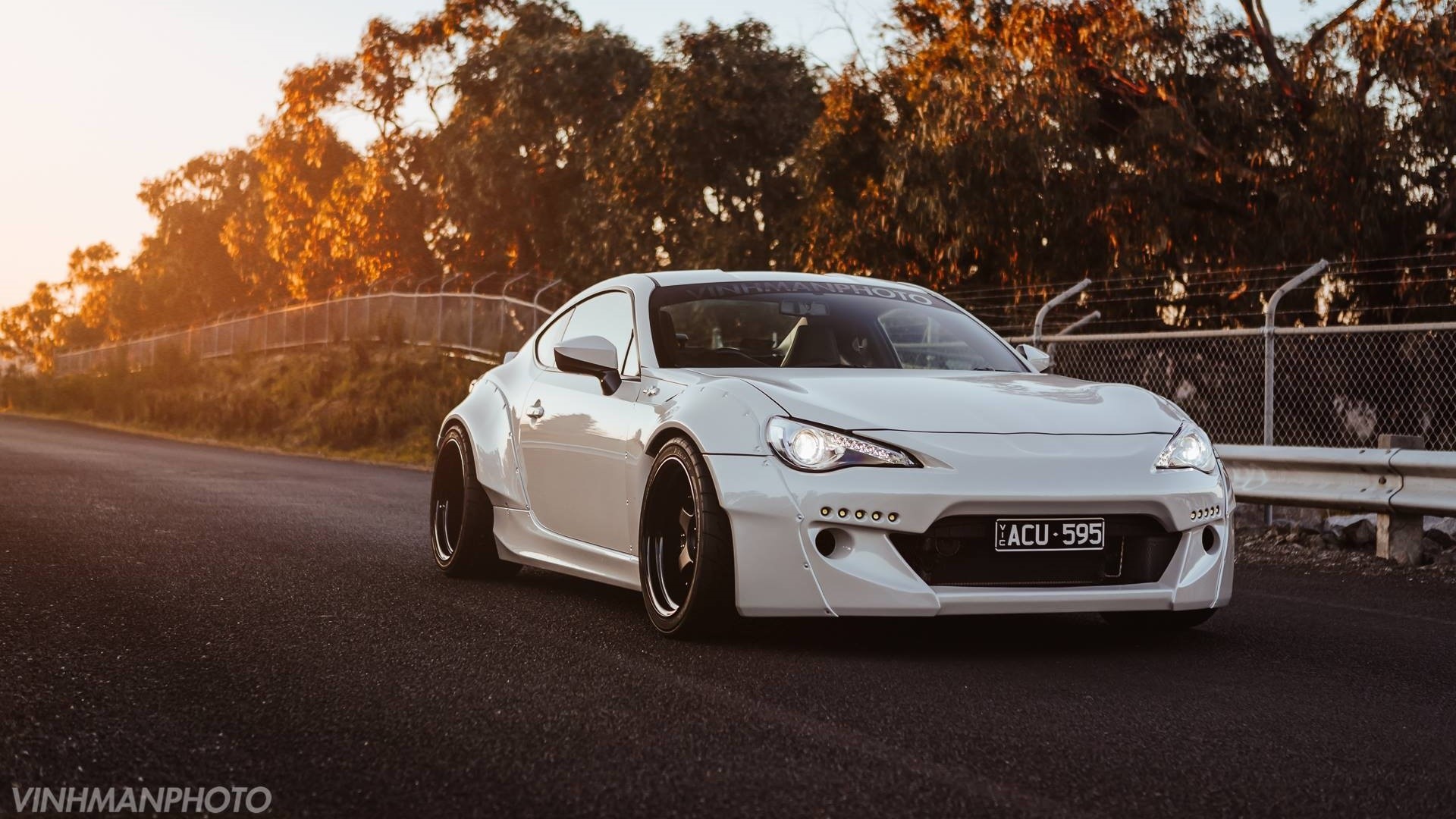 White Toyota GT86 with widebody kit on road HD Wallpaper