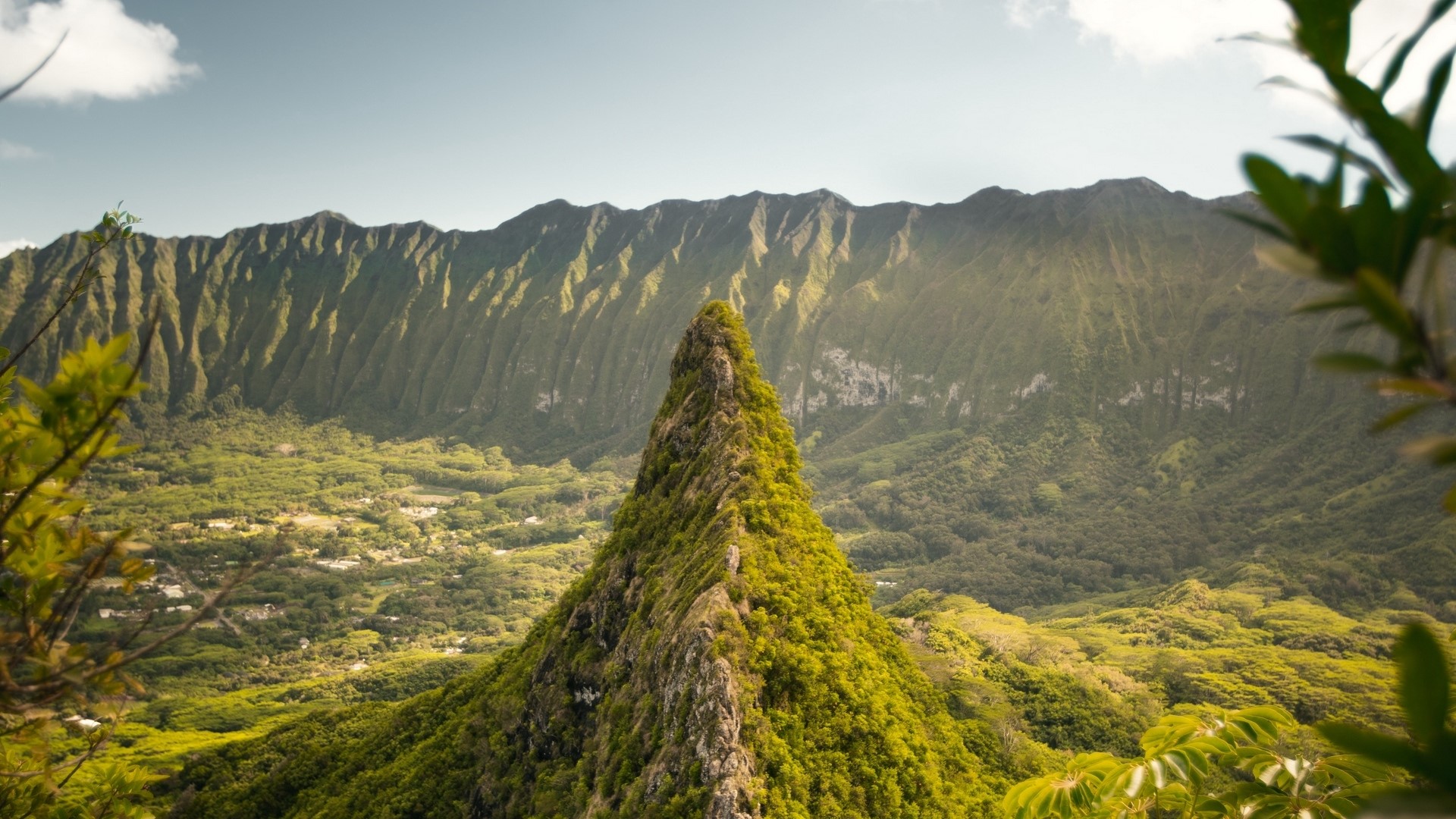 Jagged green mountain peak overlooking a valley HD Wallpaper