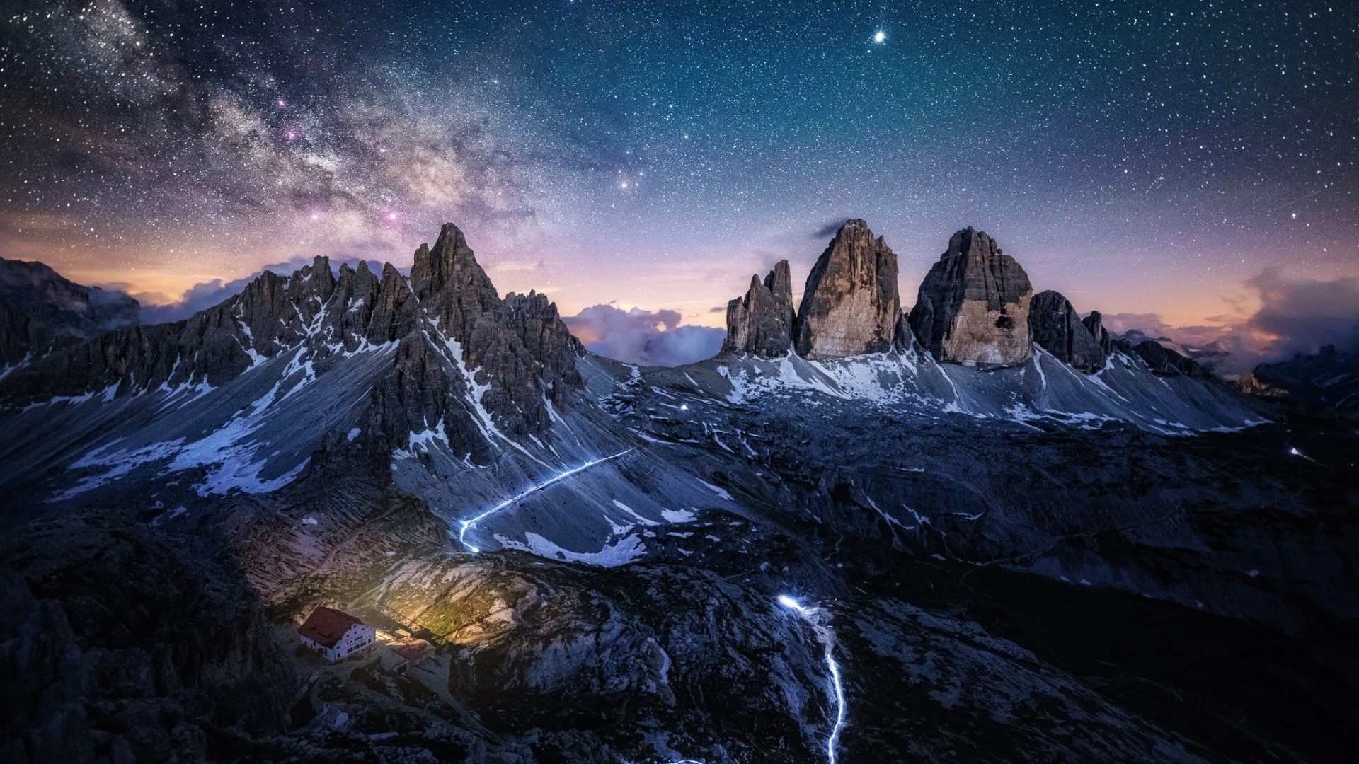 Mountain range under starry sky with a house HD Wallpaper