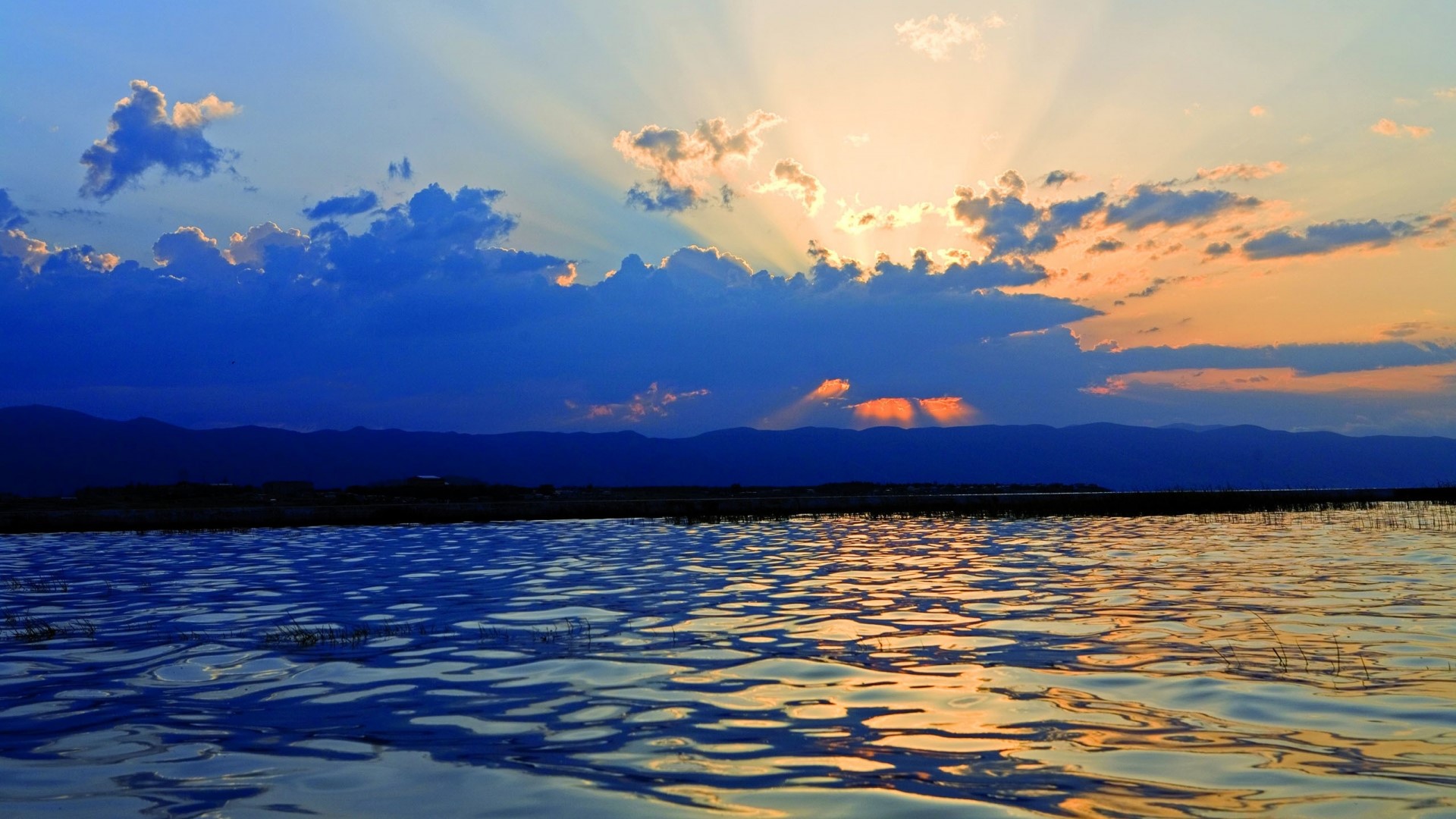 Sunset over a lake with mountains HD Wallpaper