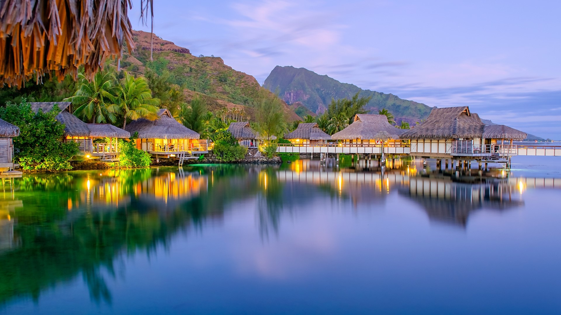 Overwater bungalows in a tropical lagoon at dusk HD Wallpaper