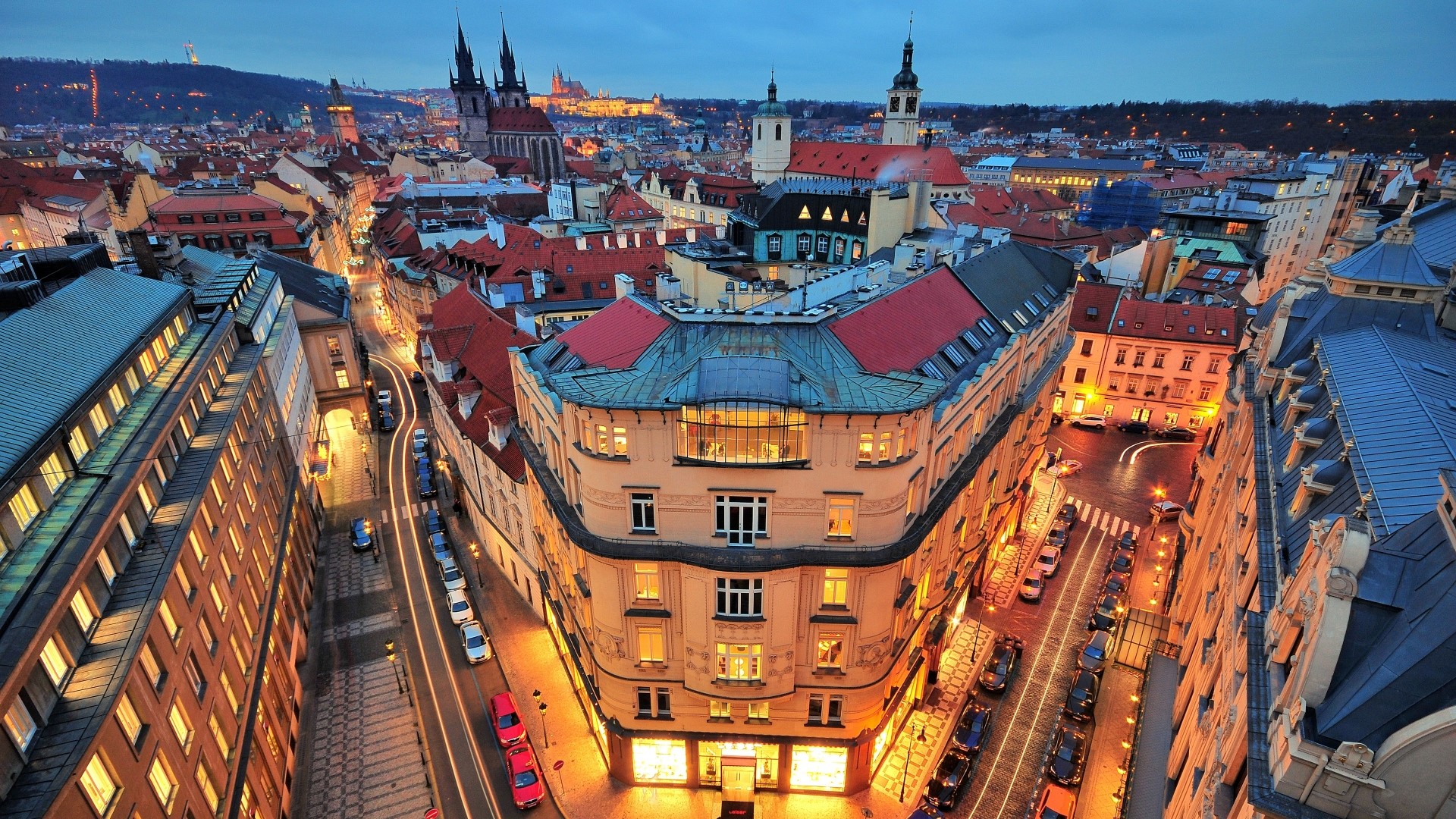 Prague cityscape at dusk with historic architecture HD Wallpaper