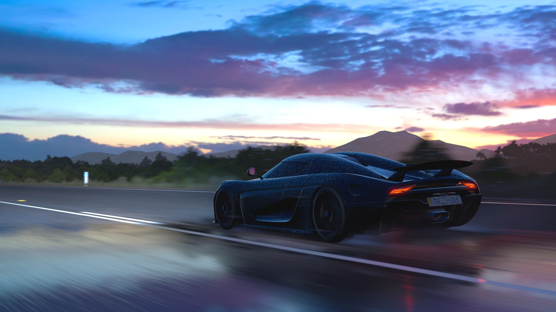 Dark sports car driving on a wet road at sunset HD Wallpaper
