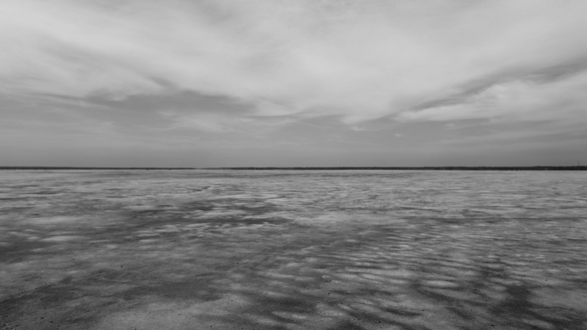 Vast flat landscape under cloudy sky HD Wallpaper
