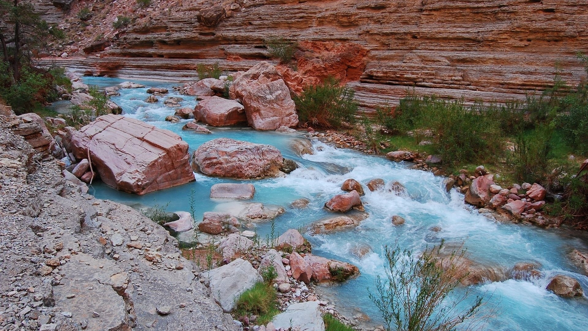 Turquoise river flowing through a rocky canyon HD Wallpaper