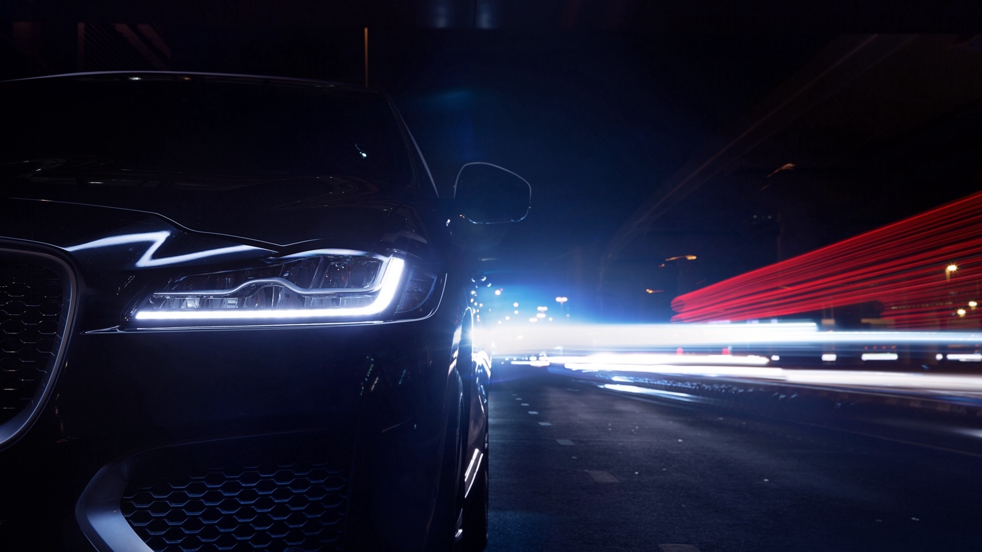 Jaguar F-Pace driving at night with light trails HD Wallpaper