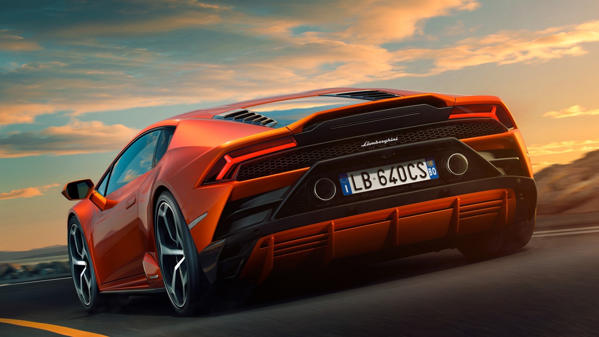 Orange Lamborghini Huracan EVO driving on road HD Wallpaper