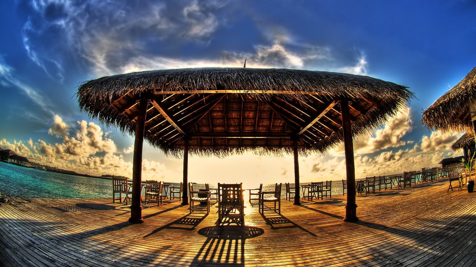 Tropical resort with thatched roofs and ocean view HD Wallpaper