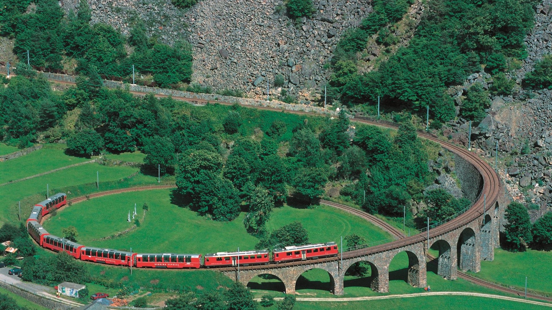 Red train on a viaduct in Switzerland HD Wallpaper