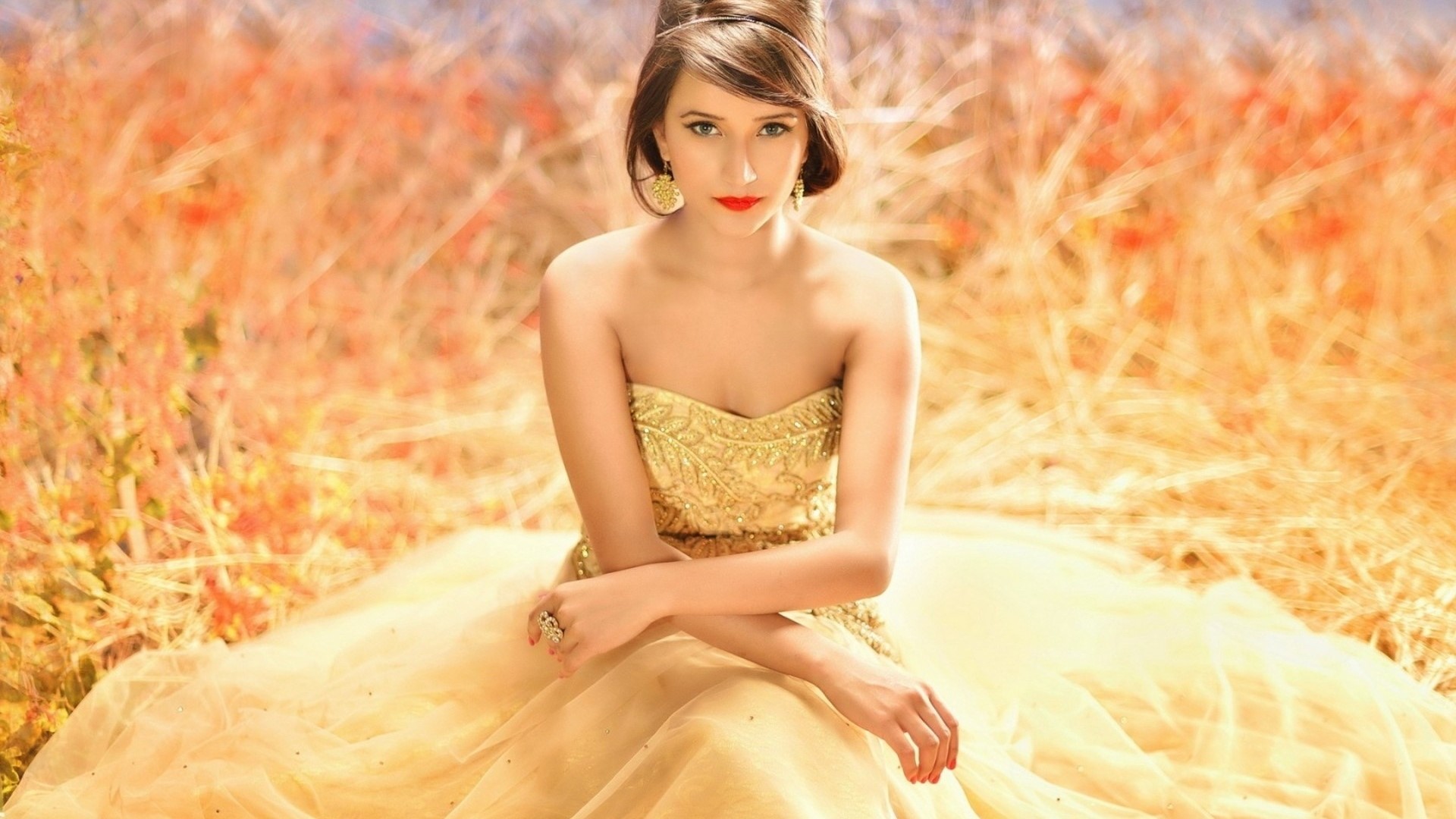 Brunette woman in a gold dress HD Wallpaper