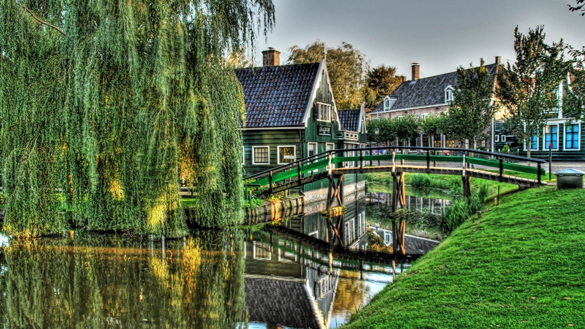 Green houses and bridge over canal in Dutch village HD Wallpaper