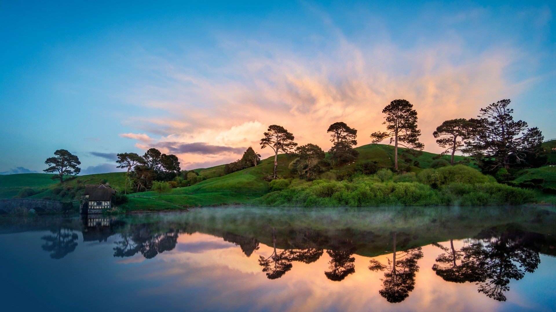 Sunset over a lake with a hobbit house HD Wallpaper
