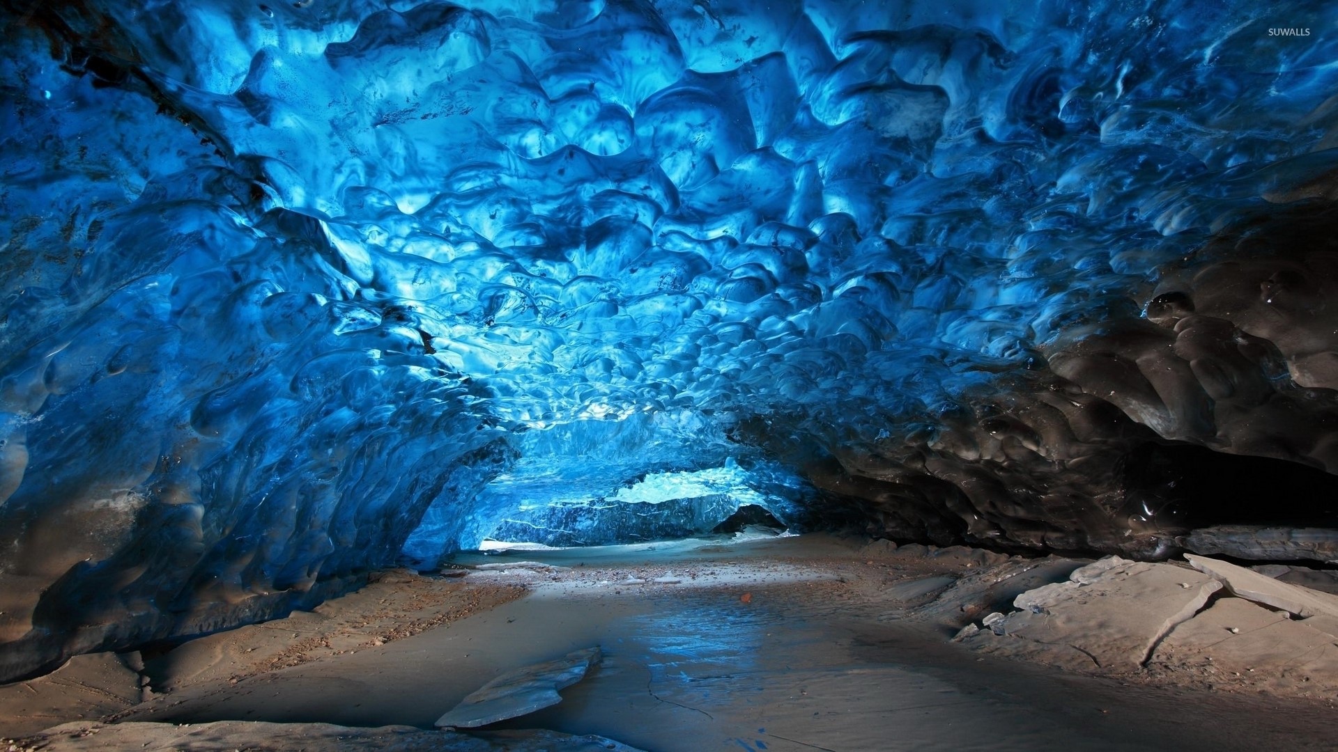 Blue ice cave with frozen river HD Wallpaper