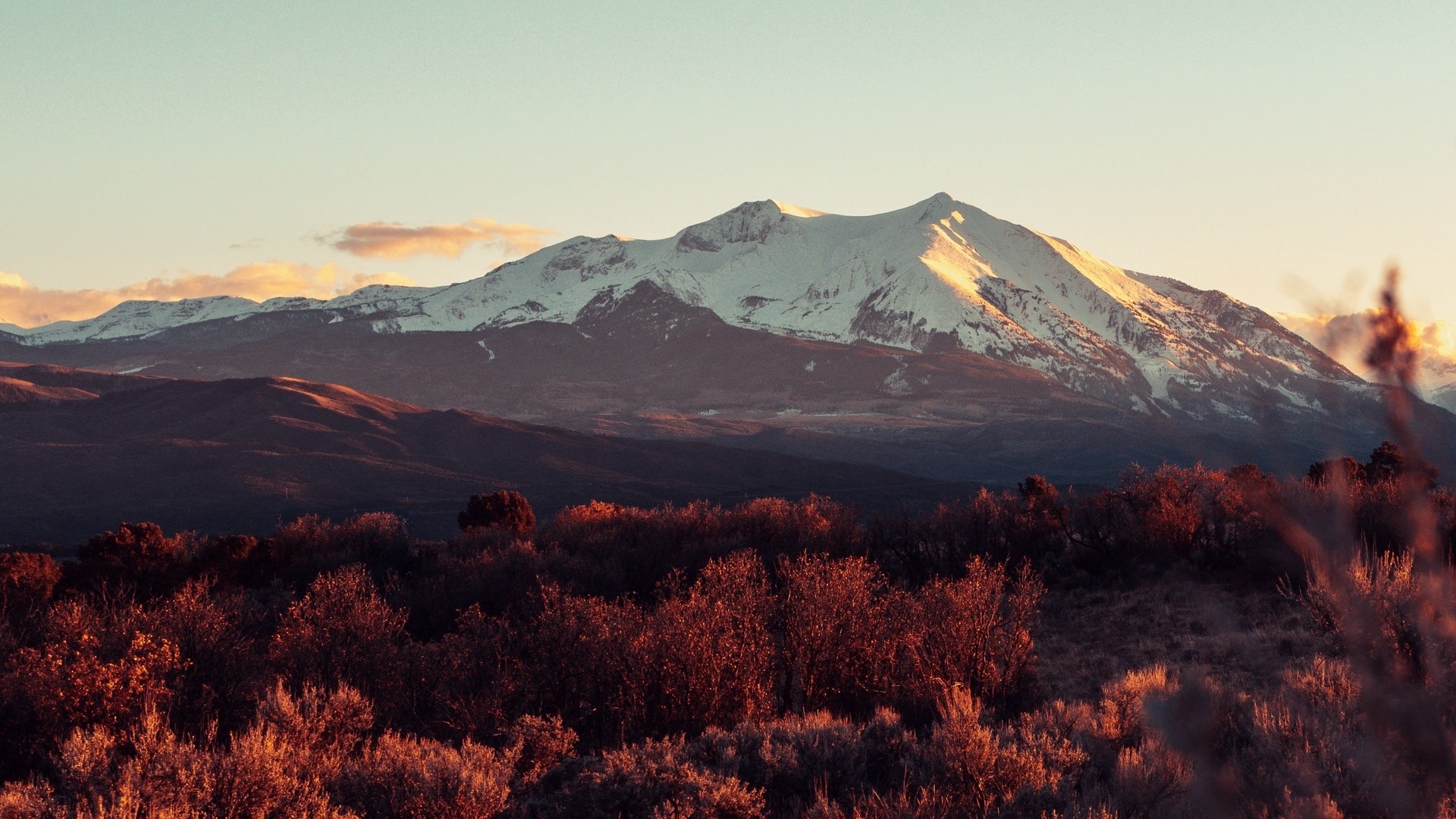 Snow-capped mountain range at sunset HD Wallpaper