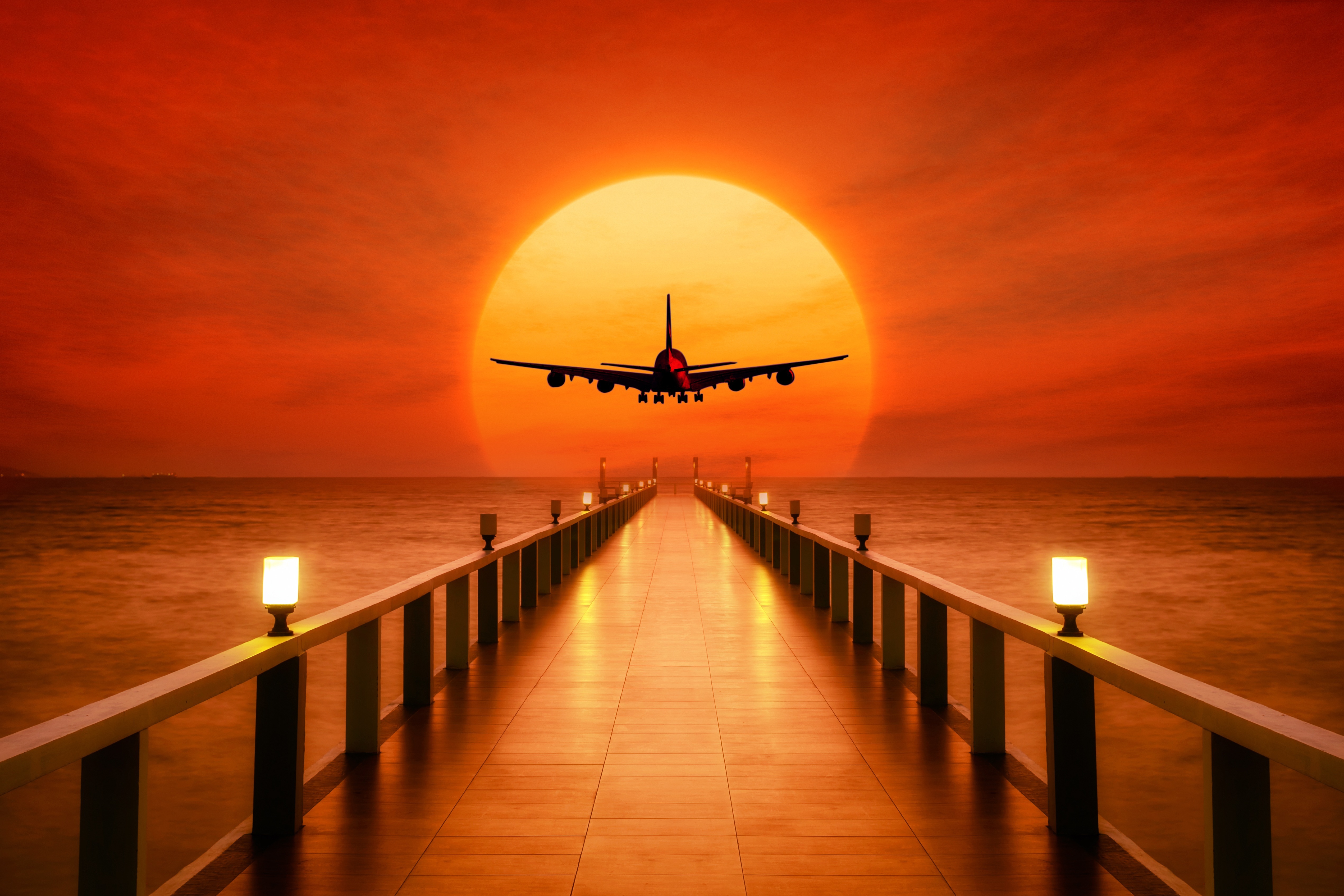 Airplane flying over pier at sunset HD Wallpaper