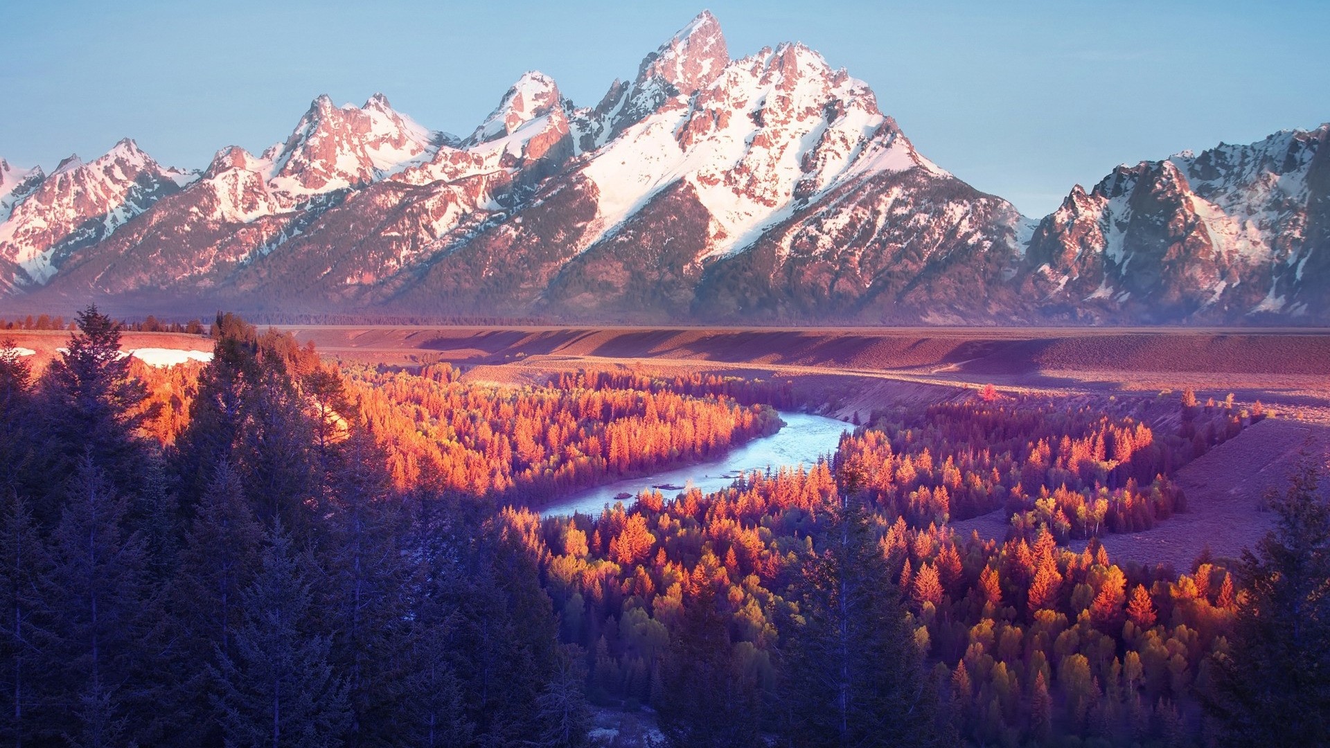 Snow-capped mountains over a river valley at sunrise HD Wallpaper