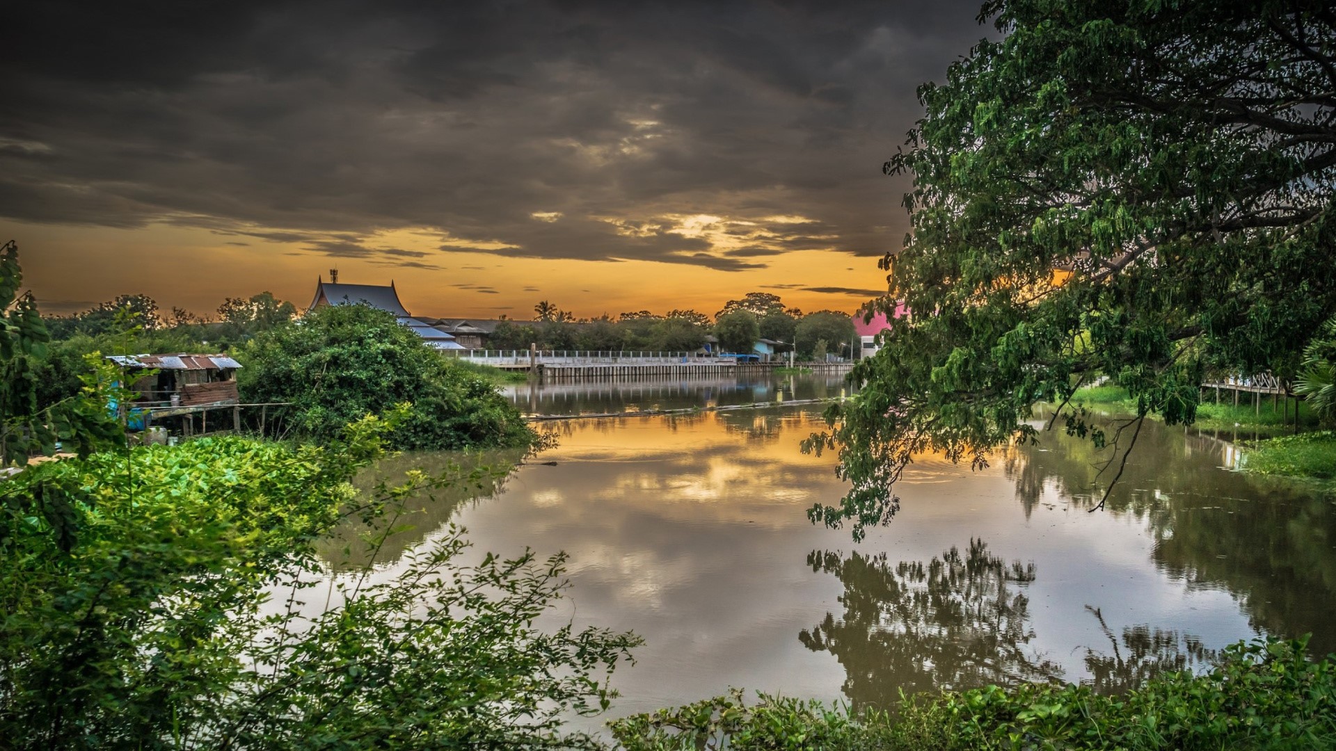 River landscape with traditional buildings at sunset HD Wallpaper