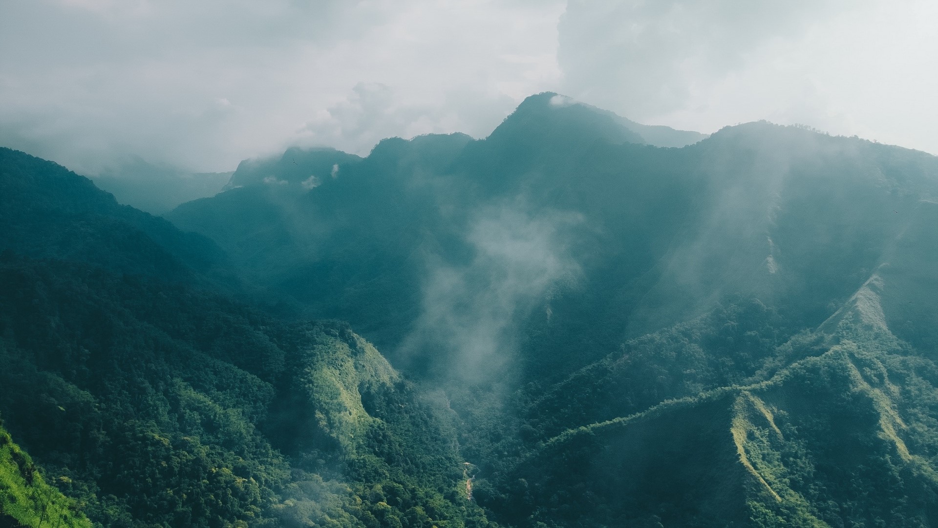 Aerial view of misty green mountains HD Wallpaper
