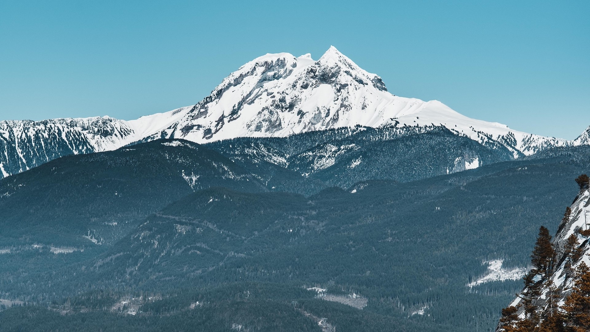 Snow-capped mountains under a clear blue sky HD Wallpaper