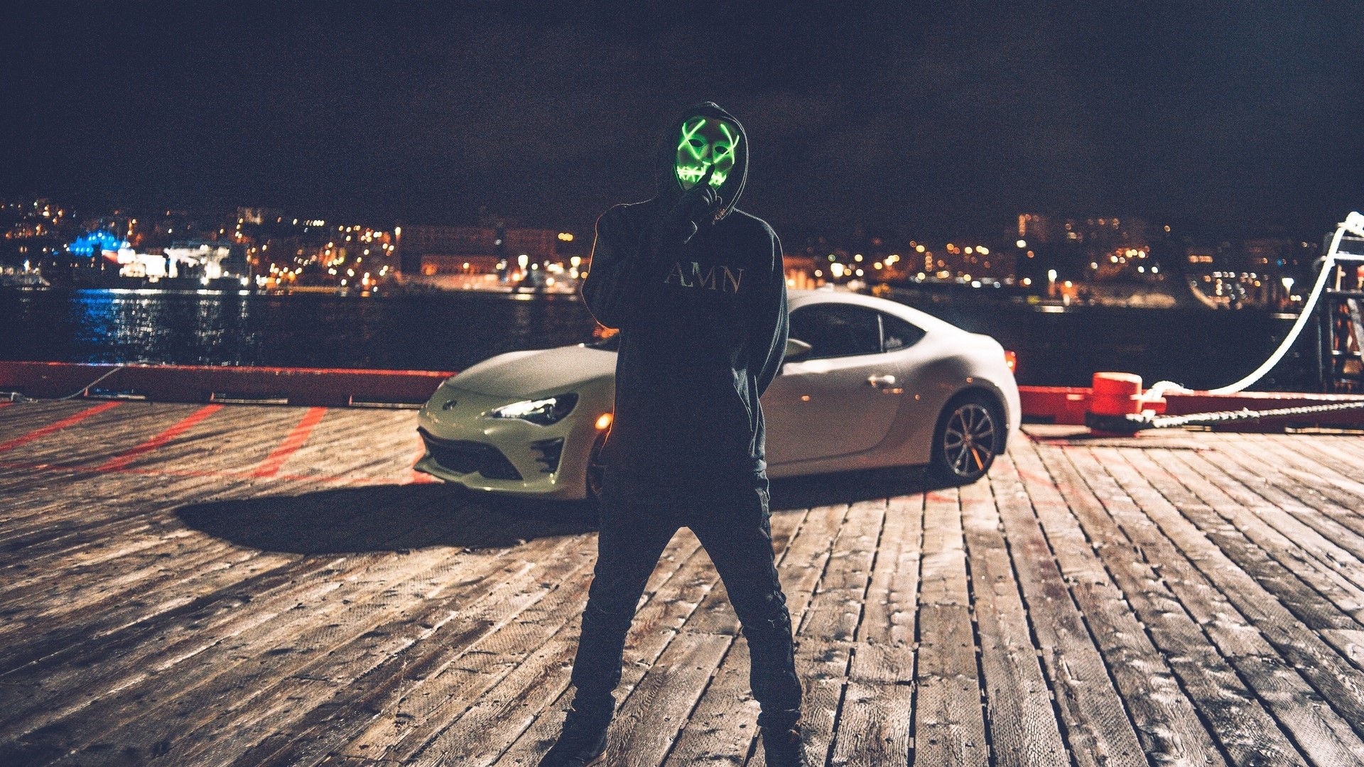 Person in Anonymous mask with car at night HD Wallpaper