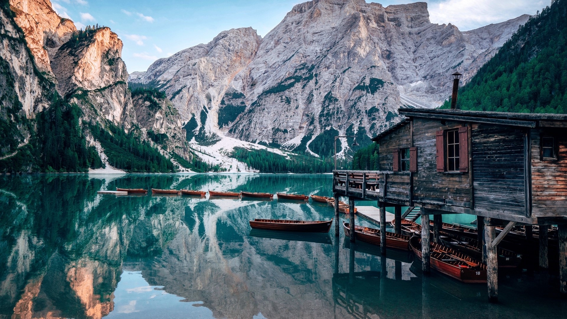 Wooden boathouse on a lake with mountains HD Wallpaper