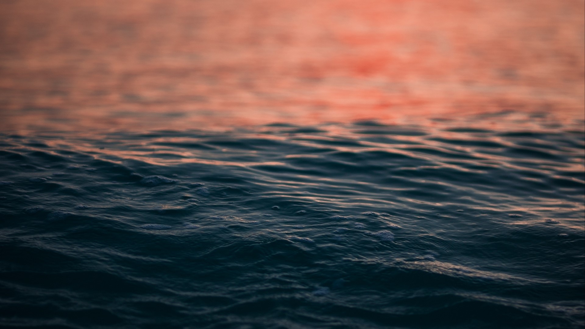 Water surface with ripples and sunset reflection HD Wallpaper
