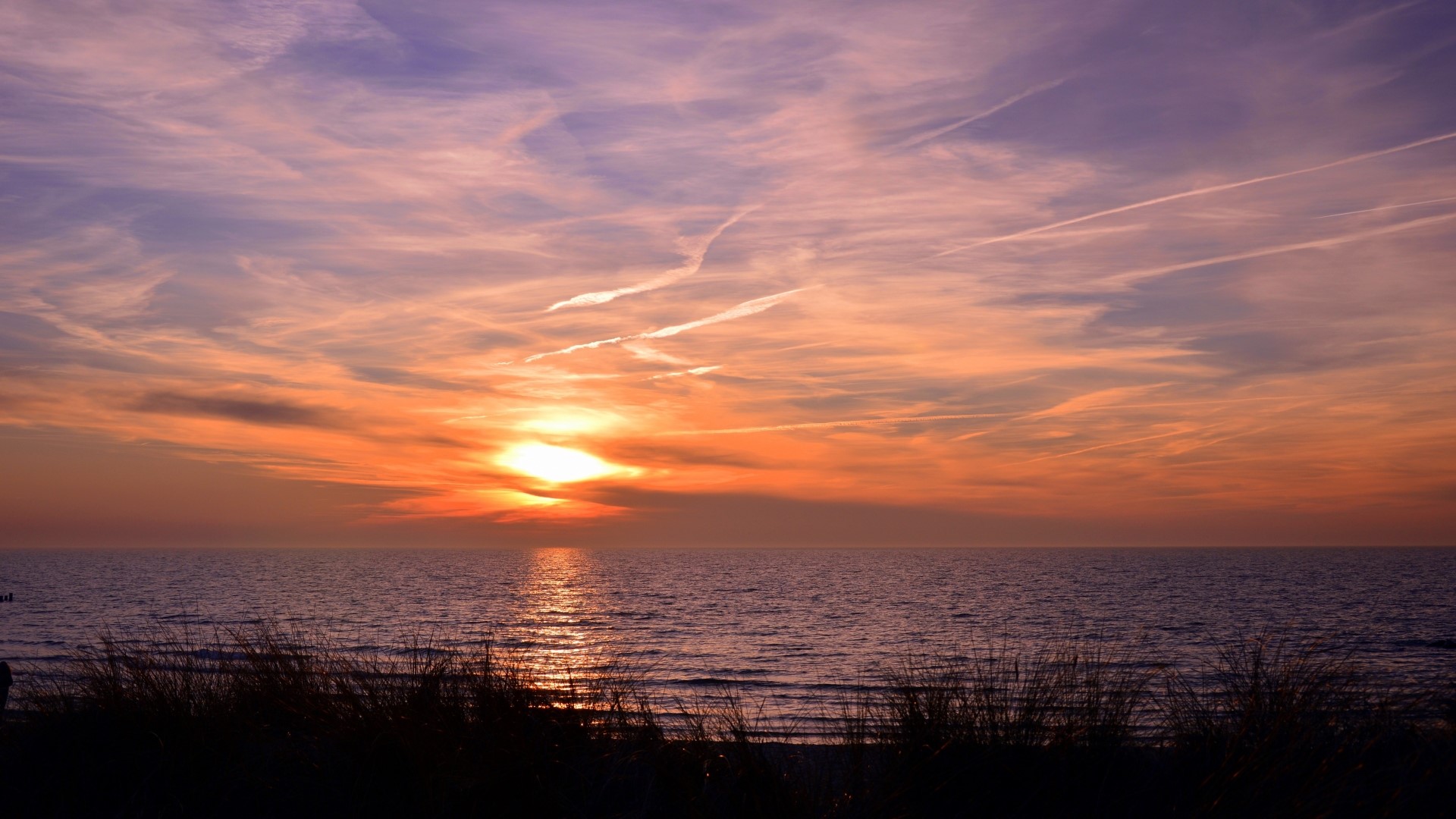 Sunset over the sea with clouds and grass HD Wallpaper