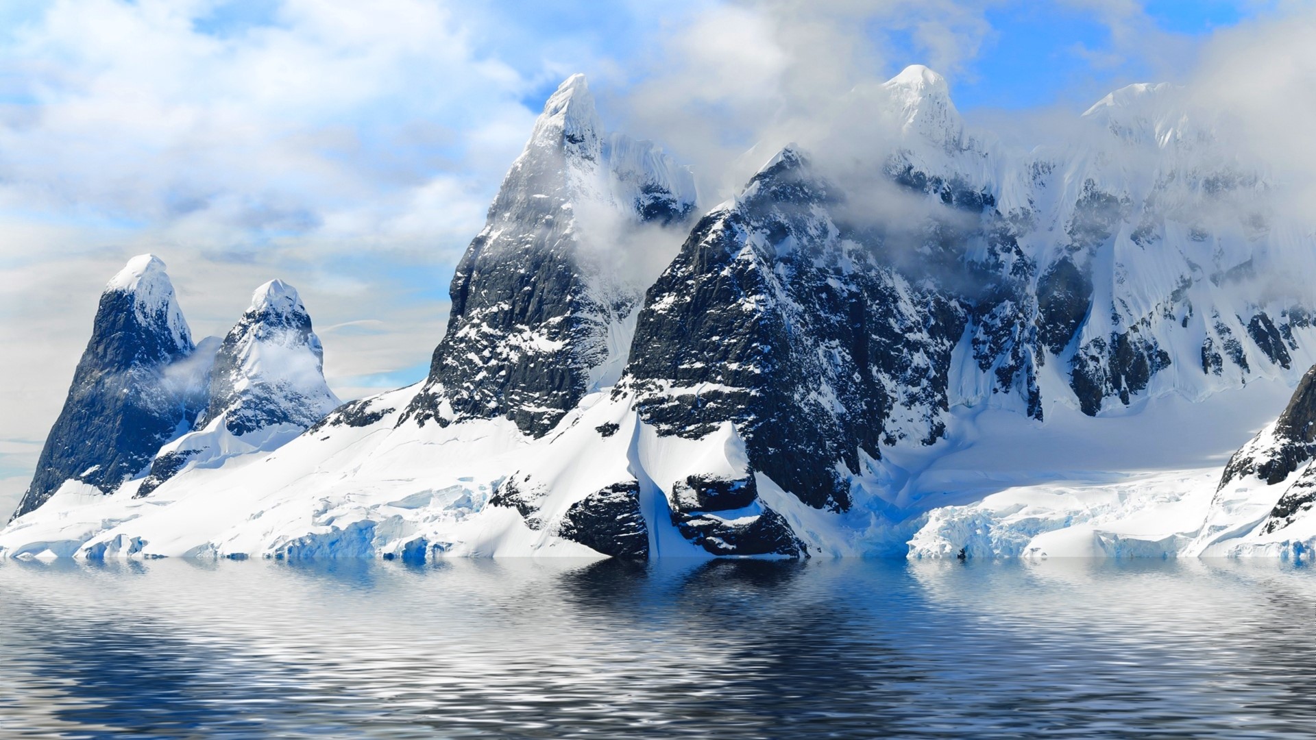 Snow-capped mountains reflected in water HD Wallpaper