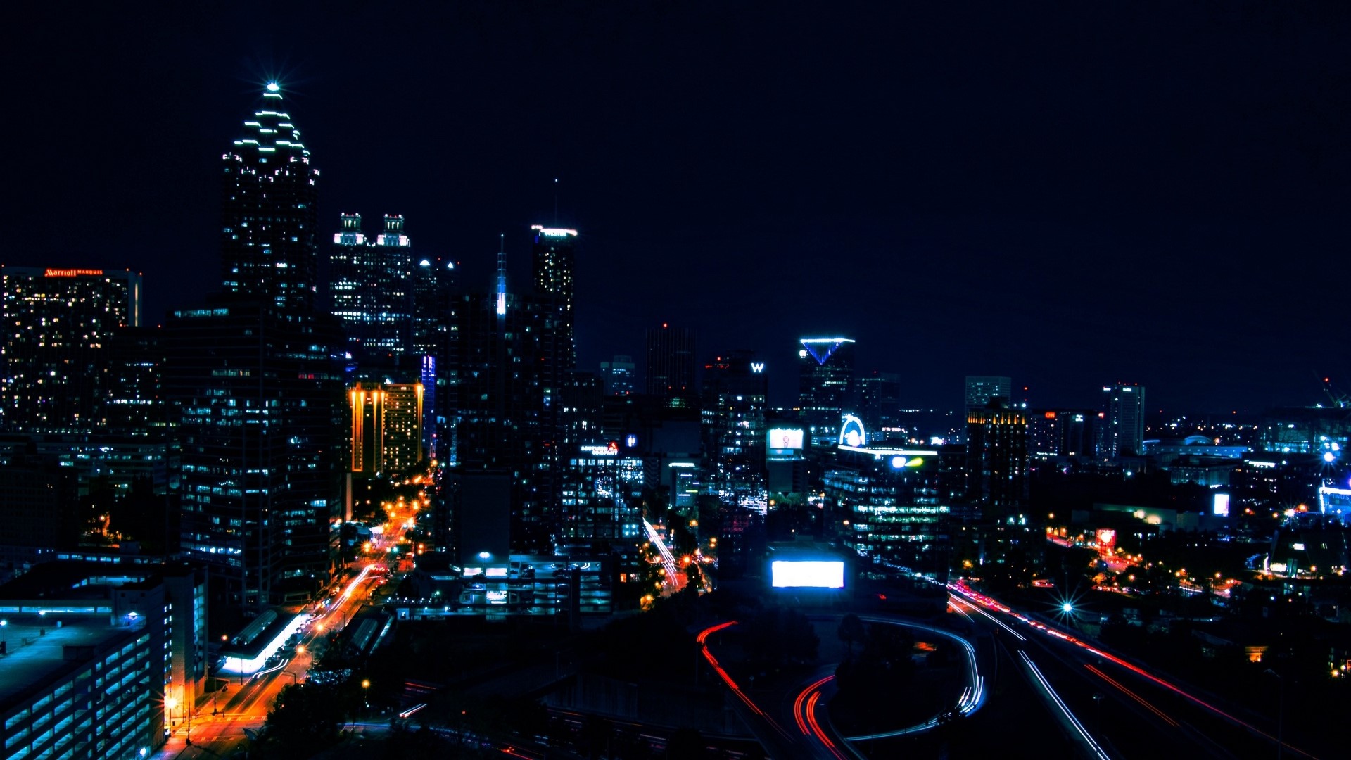 Night city skyline with light trails HD Wallpaper