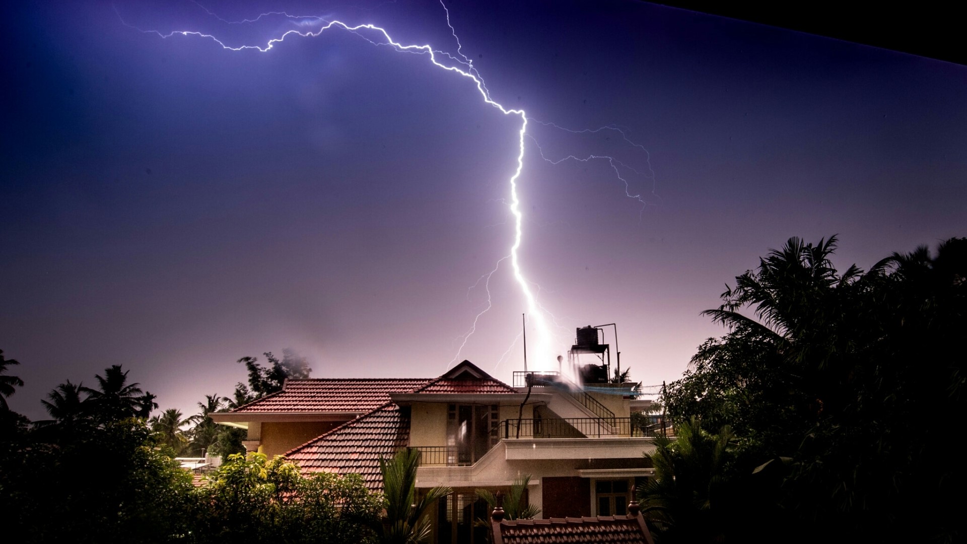 Lightning strikes a house during a storm HD Wallpaper