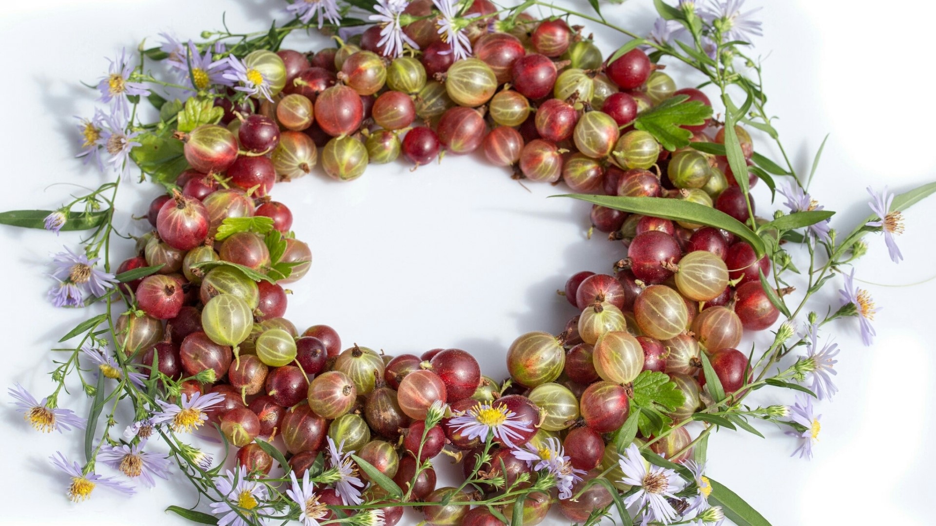 Gooseberries and purple flowers arranged in a wreath HD Wallpaper